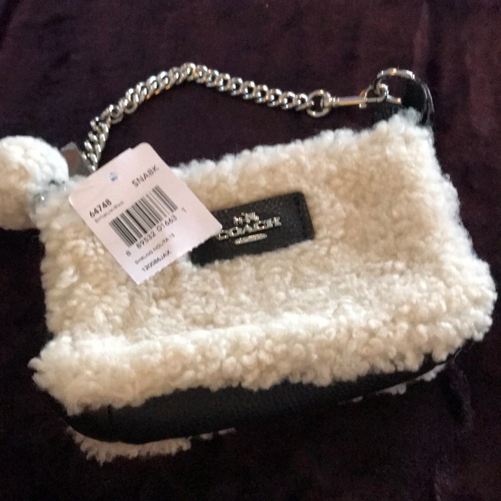 NWT Coach Sherpa black wristlet. Cute Pom attached